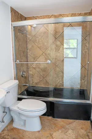 a bathroom with a toilet and a shower