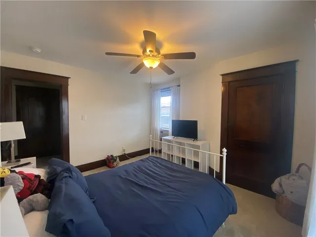 a living room with furniture and a ceiling fan