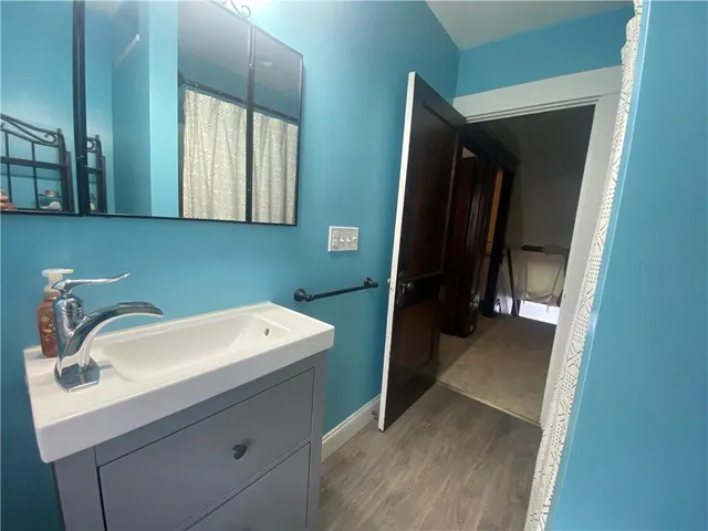 a bathroom with a glass door shower and sink
