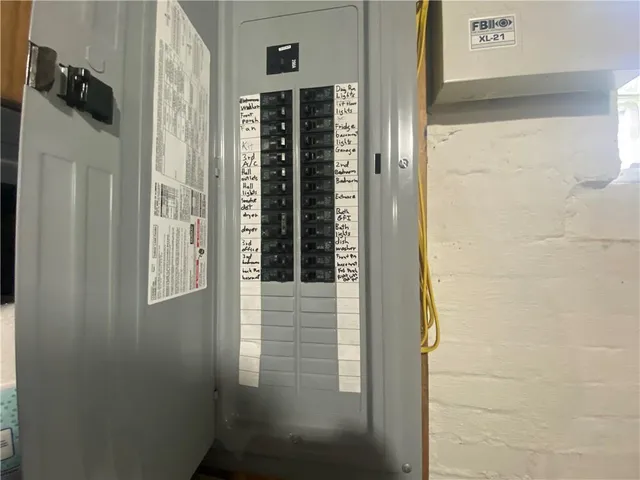 a view of a house with a big yard and a large tree