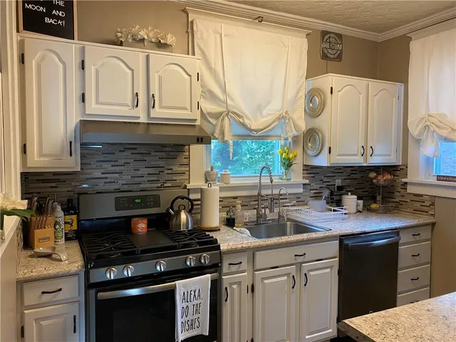 a kitchen with stainless steel appliances granite countertop a stove and a refrigerator