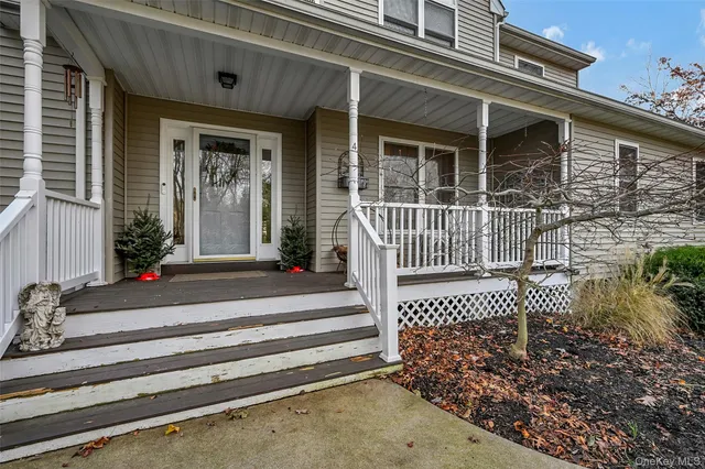 a view of a house with a large window and wooden fence