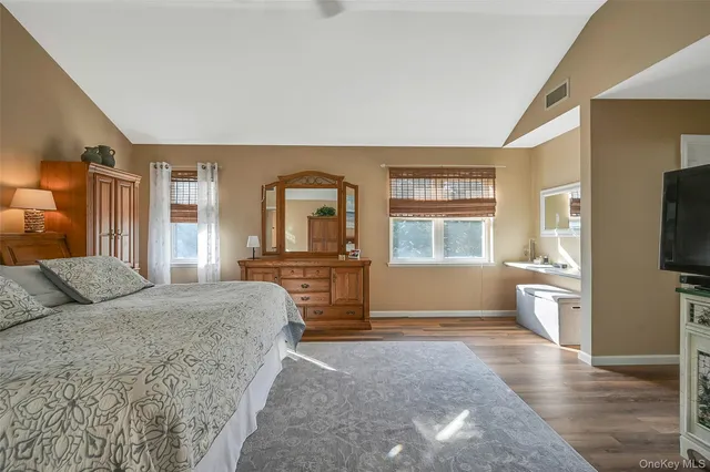 a bedroom with a large bed and a window