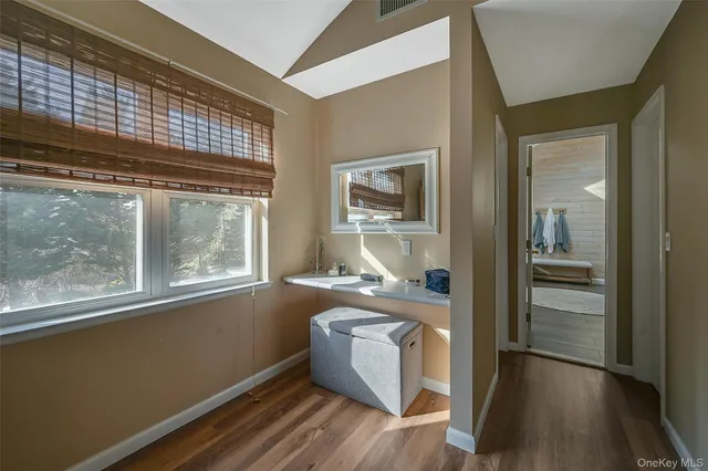 a room with a wooden floor and a large window