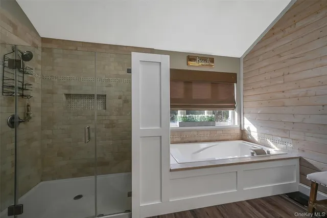 a bathroom with a shower and mirror