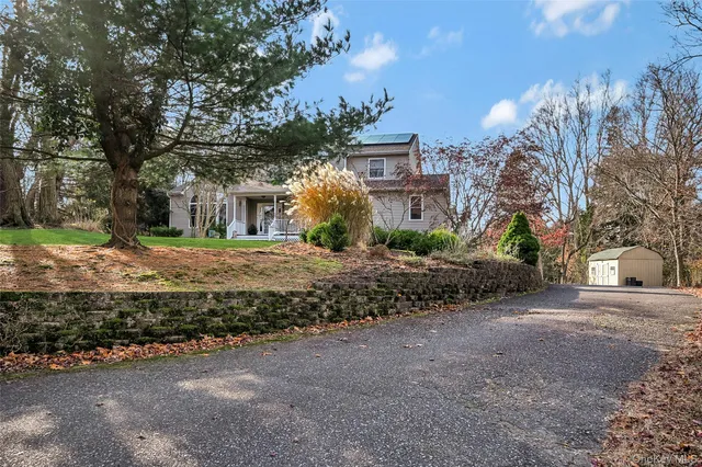 a view of a house with a yard and tree s