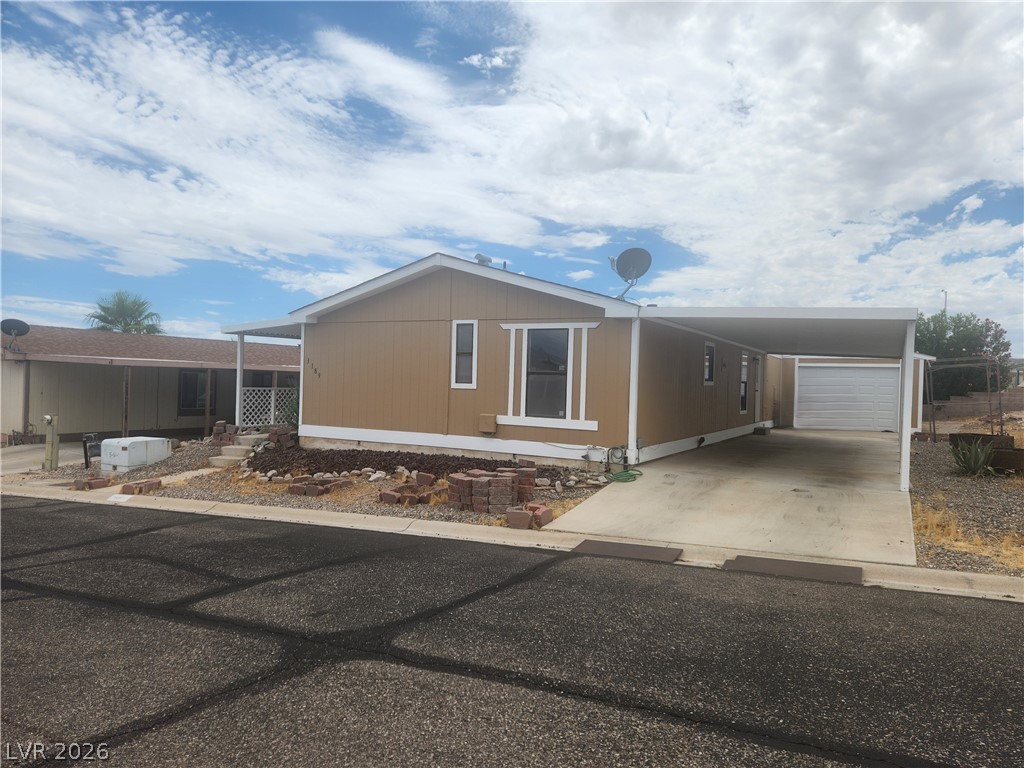 3189 Del Monte Street Laughlin, NV 89029 - Photo 2 of 32 An inviting exterior with a covered carport offers sheltered parking and a welcoming approach.