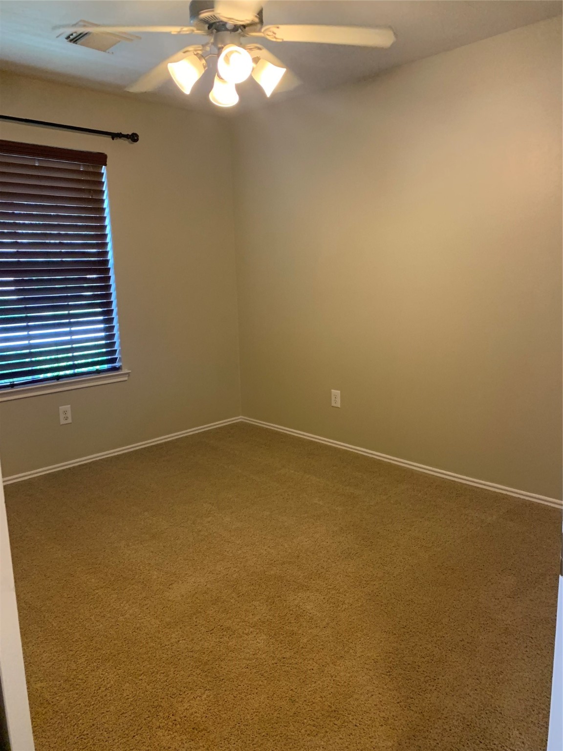 8823 Old Maple Lane Humble, TX 77338 - Photo 7 of 13 a view of an empty room with a chandelier fan