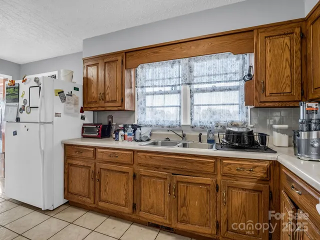 a kitchen with stainless steel appliances granite countertop a sink and cabinets