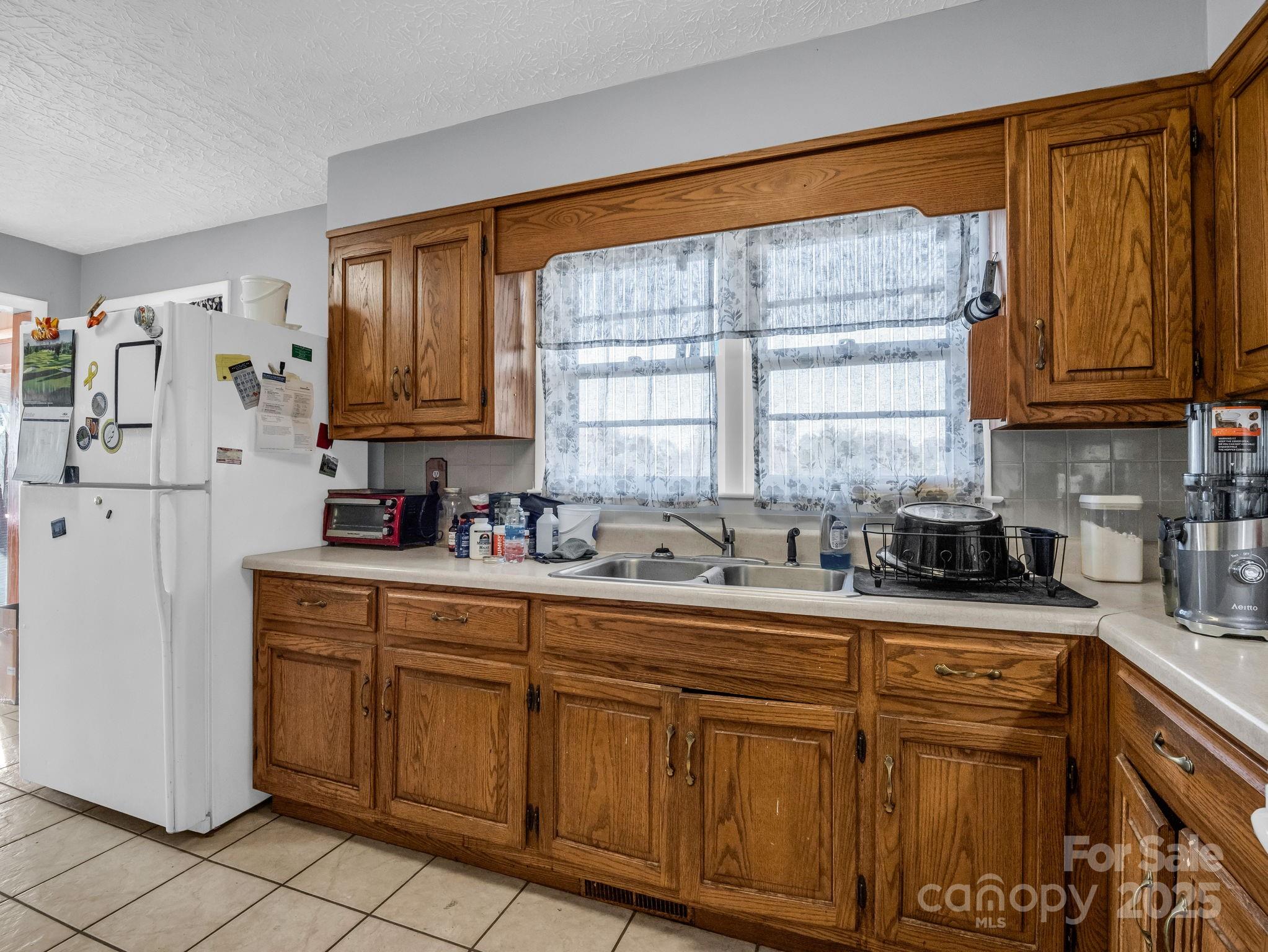 290 Stepp Mill Road Hendersonville, NC 28792 - Photo 11 of 29 a kitchen with stainless steel appliances granite countertop a sink and cabinets
