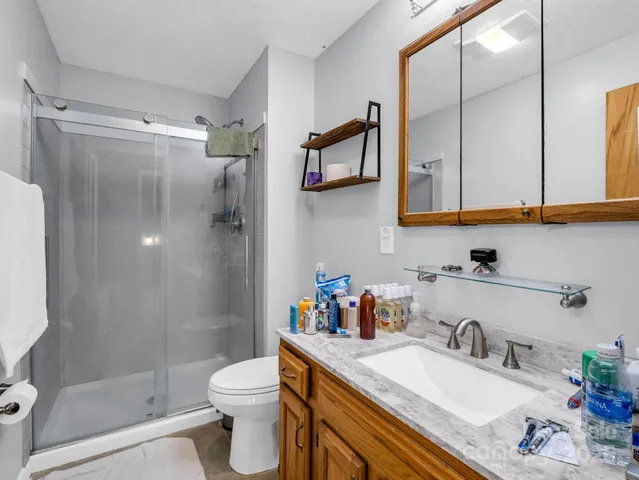 a bathroom with a sink toilet and shower