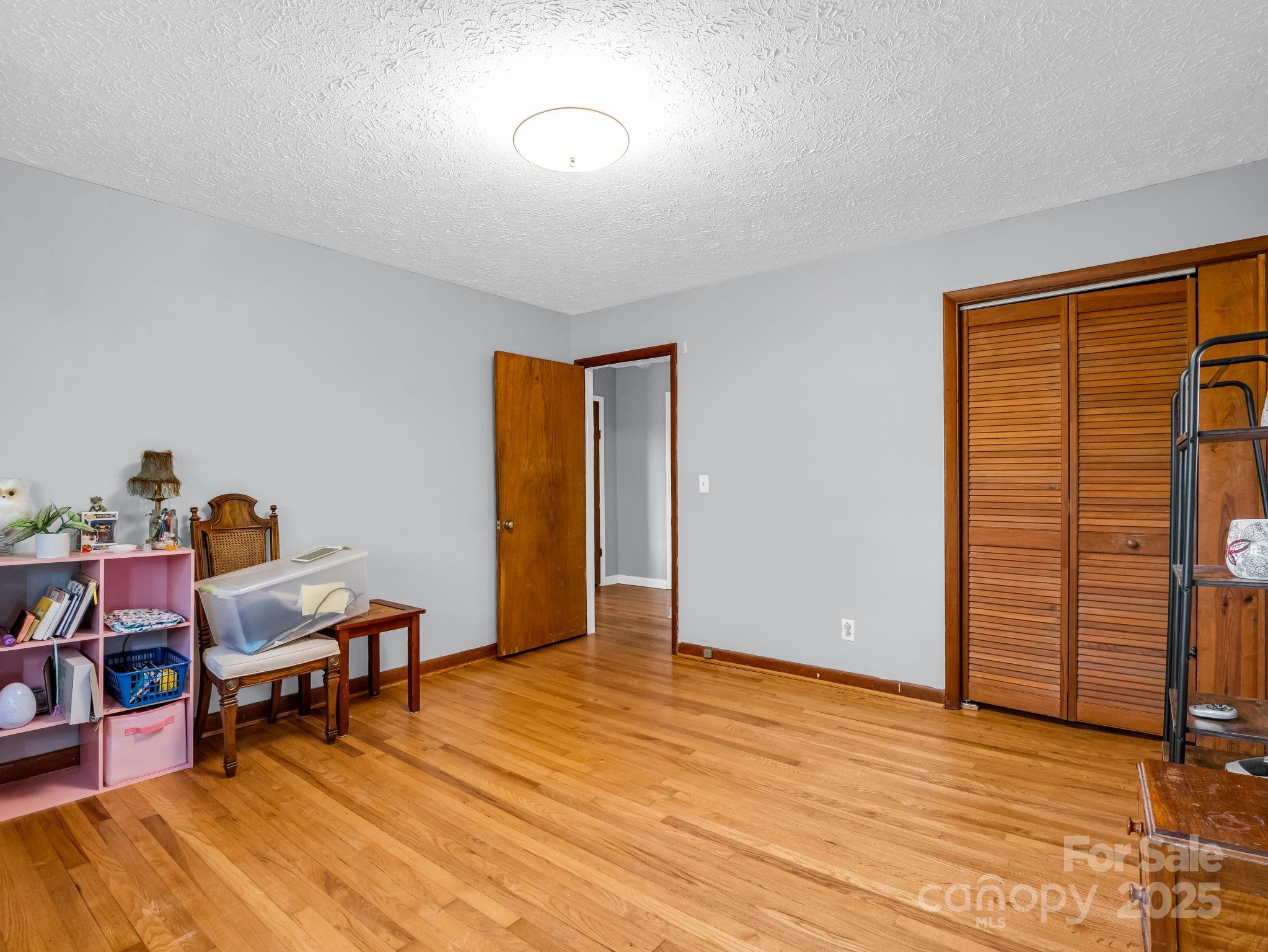 290 Stepp Mill Road Hendersonville, NC 28792 - Photo 18 of 29 a view of a workspace with furniture and wooden floor