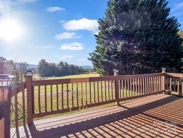 a view of a balcony with wooden floor & fence