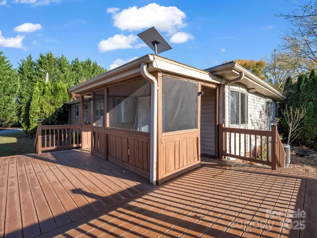 a view of a house with wooden deck