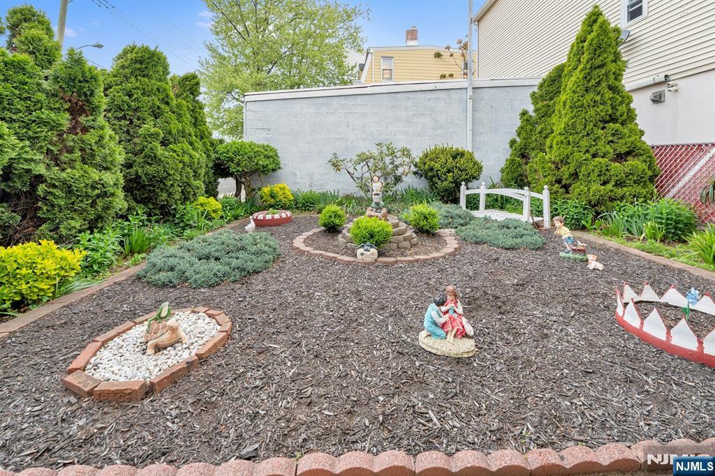 79 Washington Street Harrison, NJ 07029 - Photo 22 of 25 a view of a backyard with plants and a garden