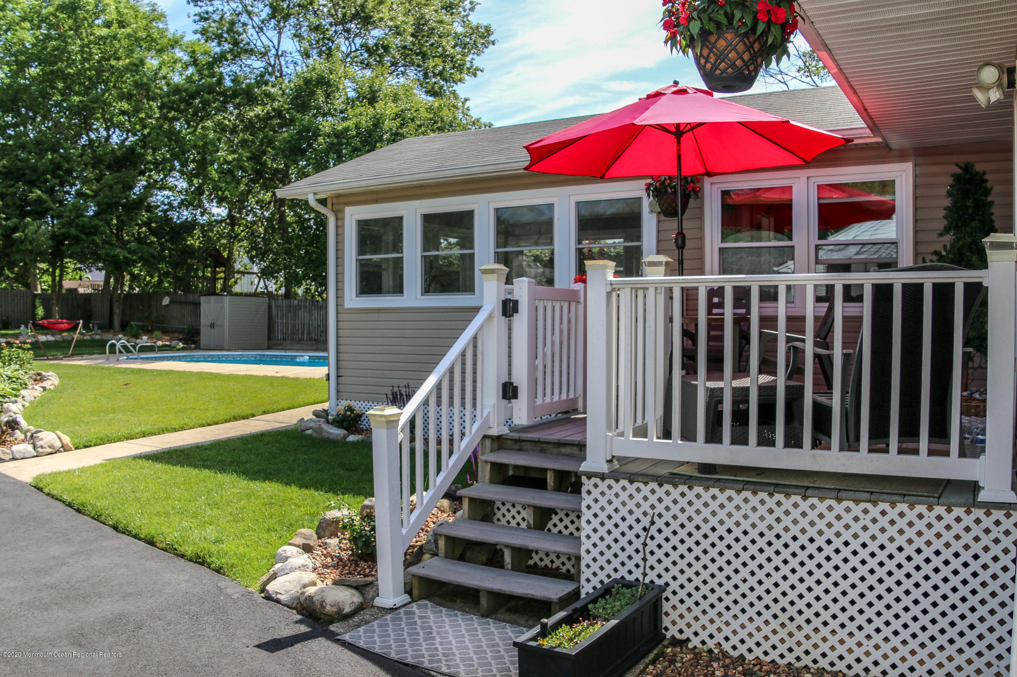 220 Wave Road Manahawkin, NJ 08050 - Photo 13 of 87 a view of a house with a swimming pool and deck