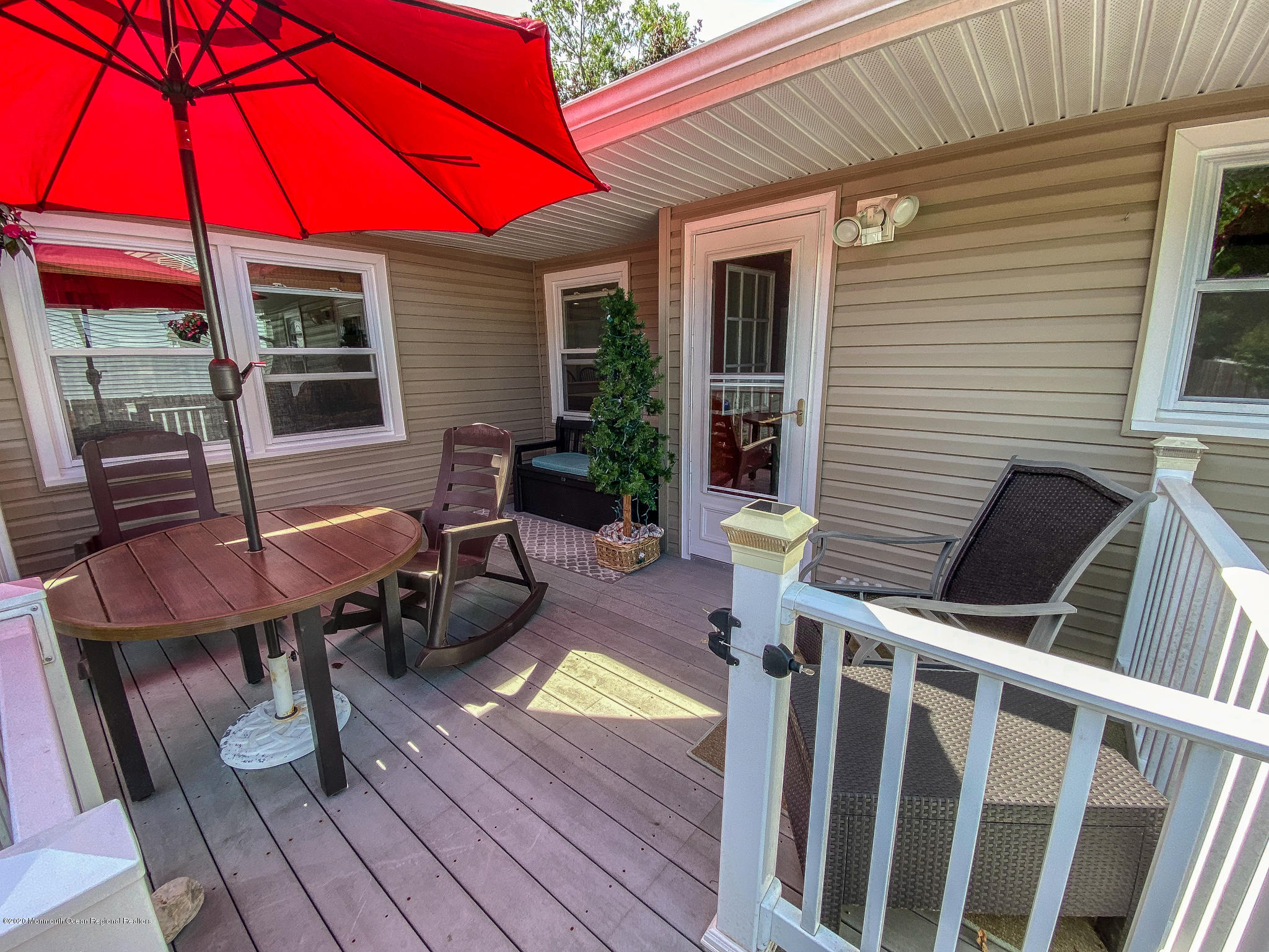 220 Wave Road Manahawkin, NJ 08050 - Photo 14 of 87 a view of deck with table and chairs under an umbrella