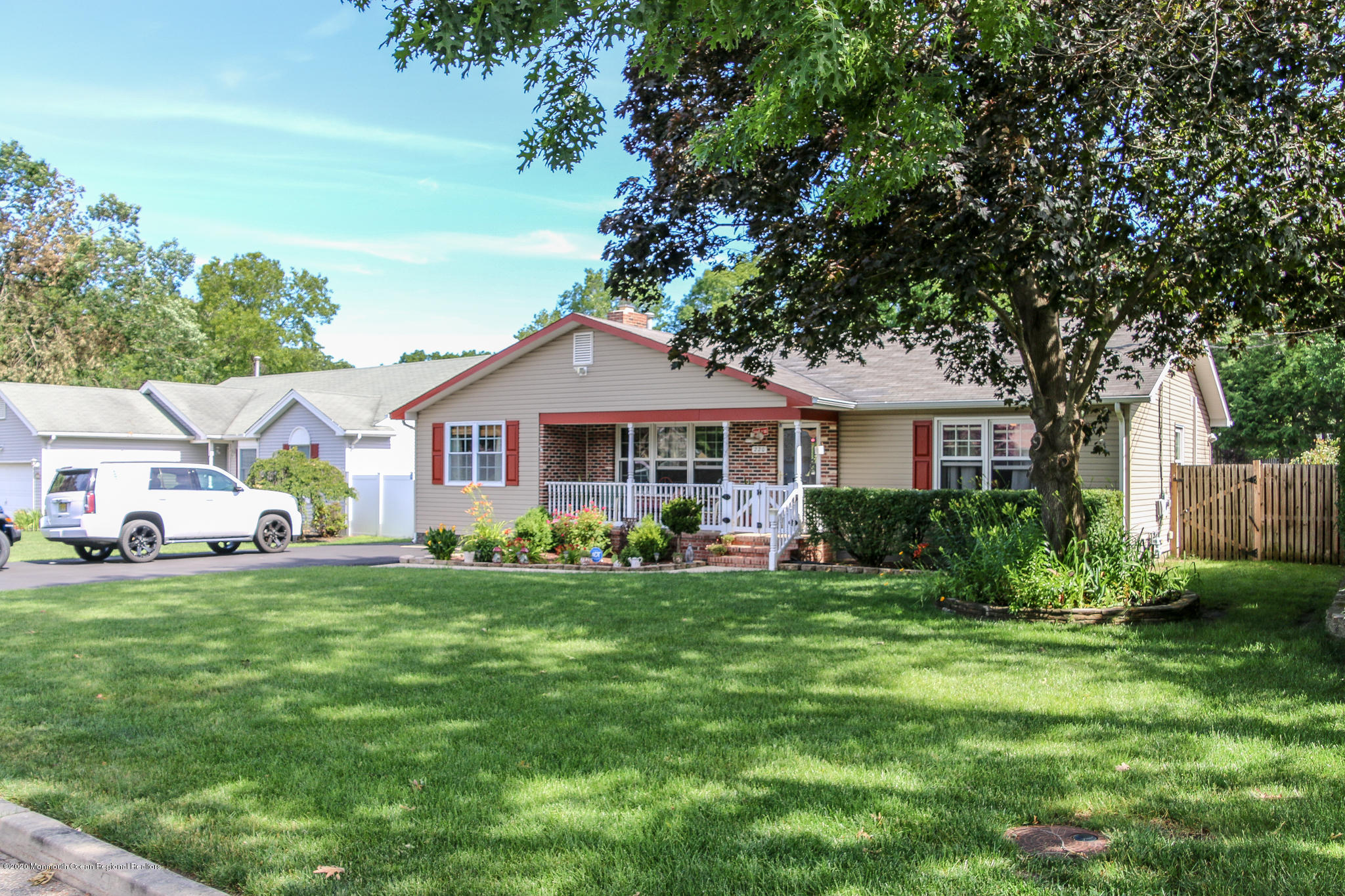 220 Wave Road Manahawkin, NJ 08050 - Photo 4 of 87 a front view of a house with a garden