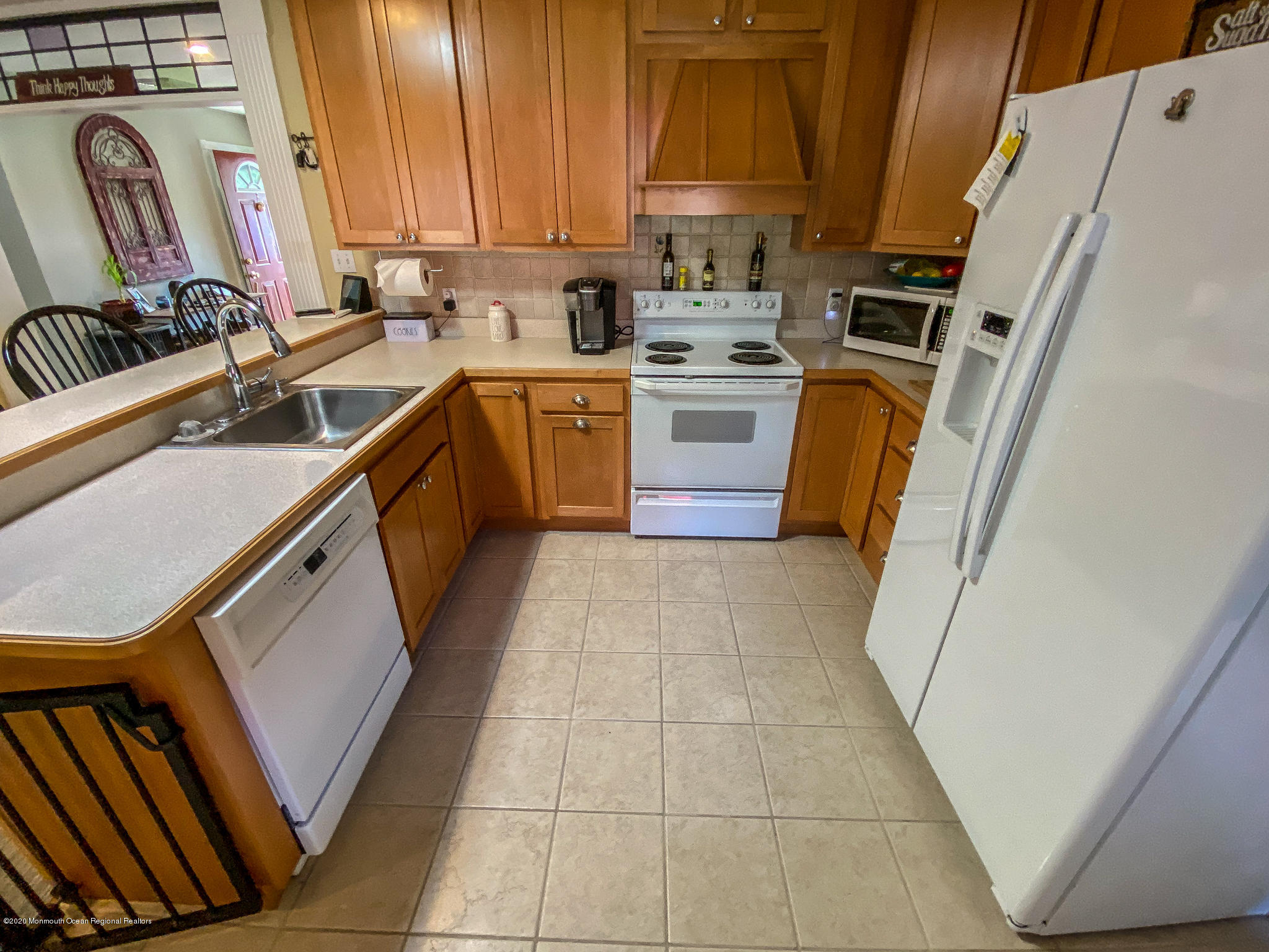 220 Wave Road Manahawkin, NJ 08050 - Photo 46 of 87 a kitchen with a sink a stove top oven a washer dryer and a view of living room
