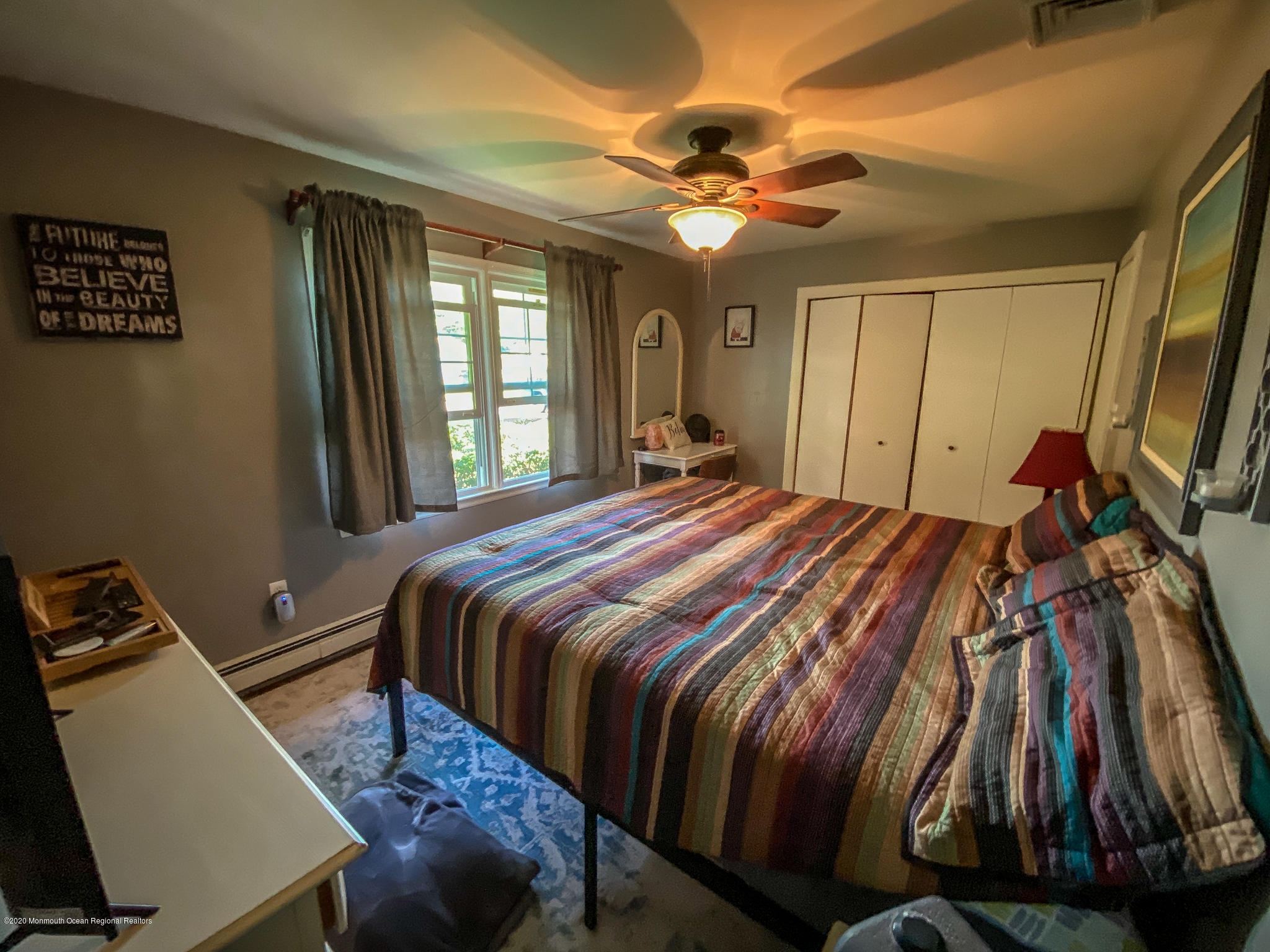 220 Wave Road Manahawkin, NJ 08050 - Photo 67 of 87 a bedroom with a bed and a chandelier