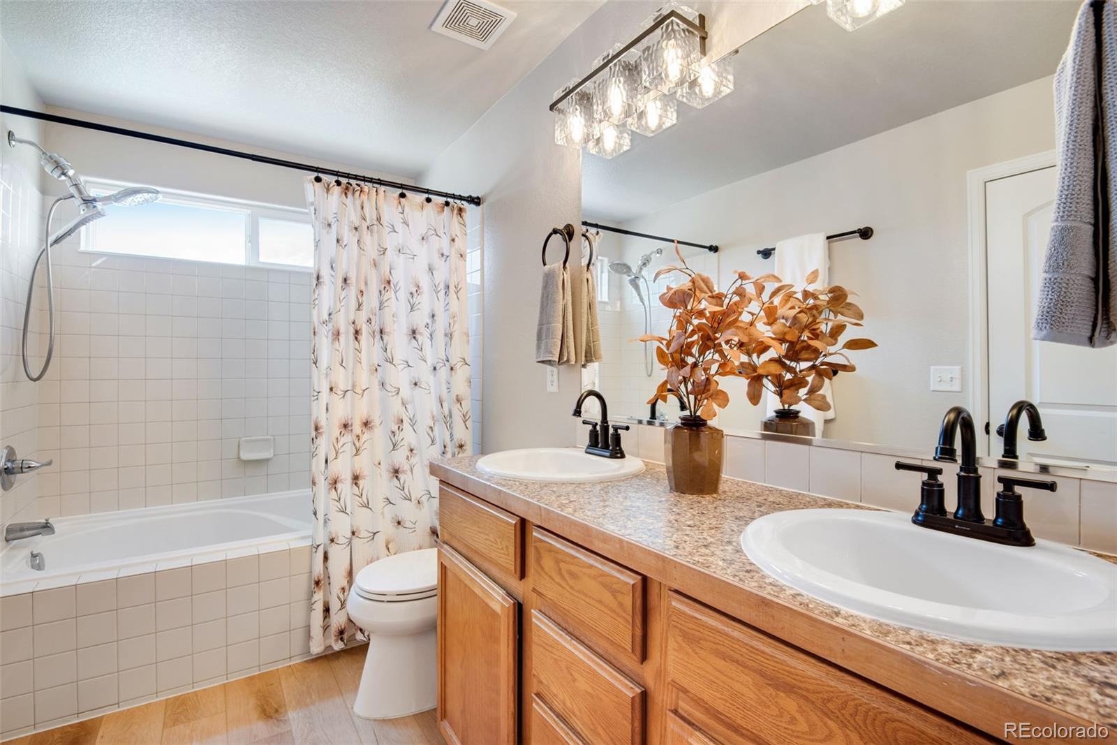 7035 McClellan Road Wellington, CO 80549 - Photo 27 of 43 a bathroom with a double vanity sink toilet and shower