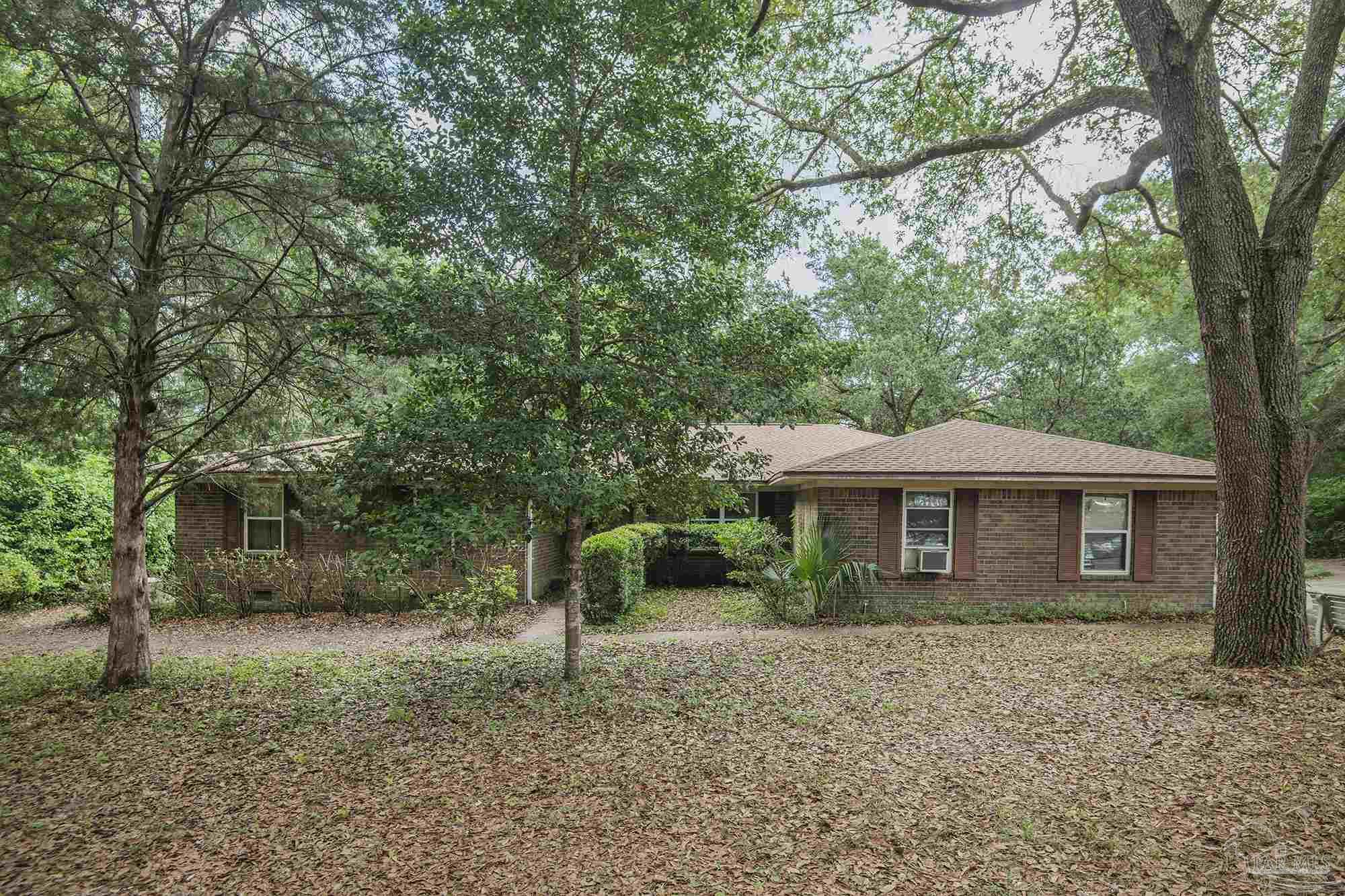 1210 Goldenrod Road Cantonment, FL 32533 - Photo 50 of 50 a front view of a house with a garden