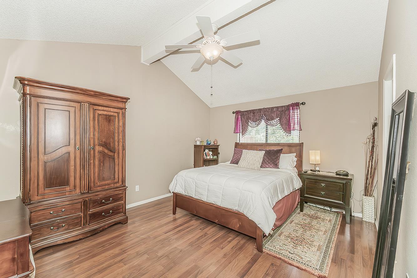 1908 East Niles Avenue Fresno, CA 93720 - Photo 13 of 30 a bedroom with a bed and wooden floor