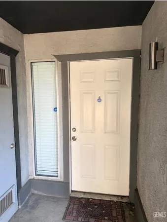 a view of a livingroom with wooden floor and a white door
