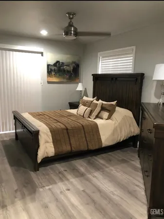 a bedroom with bed and a night stand