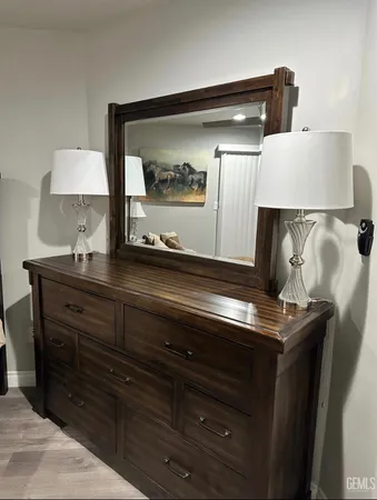 a sink with a mirror and lamp