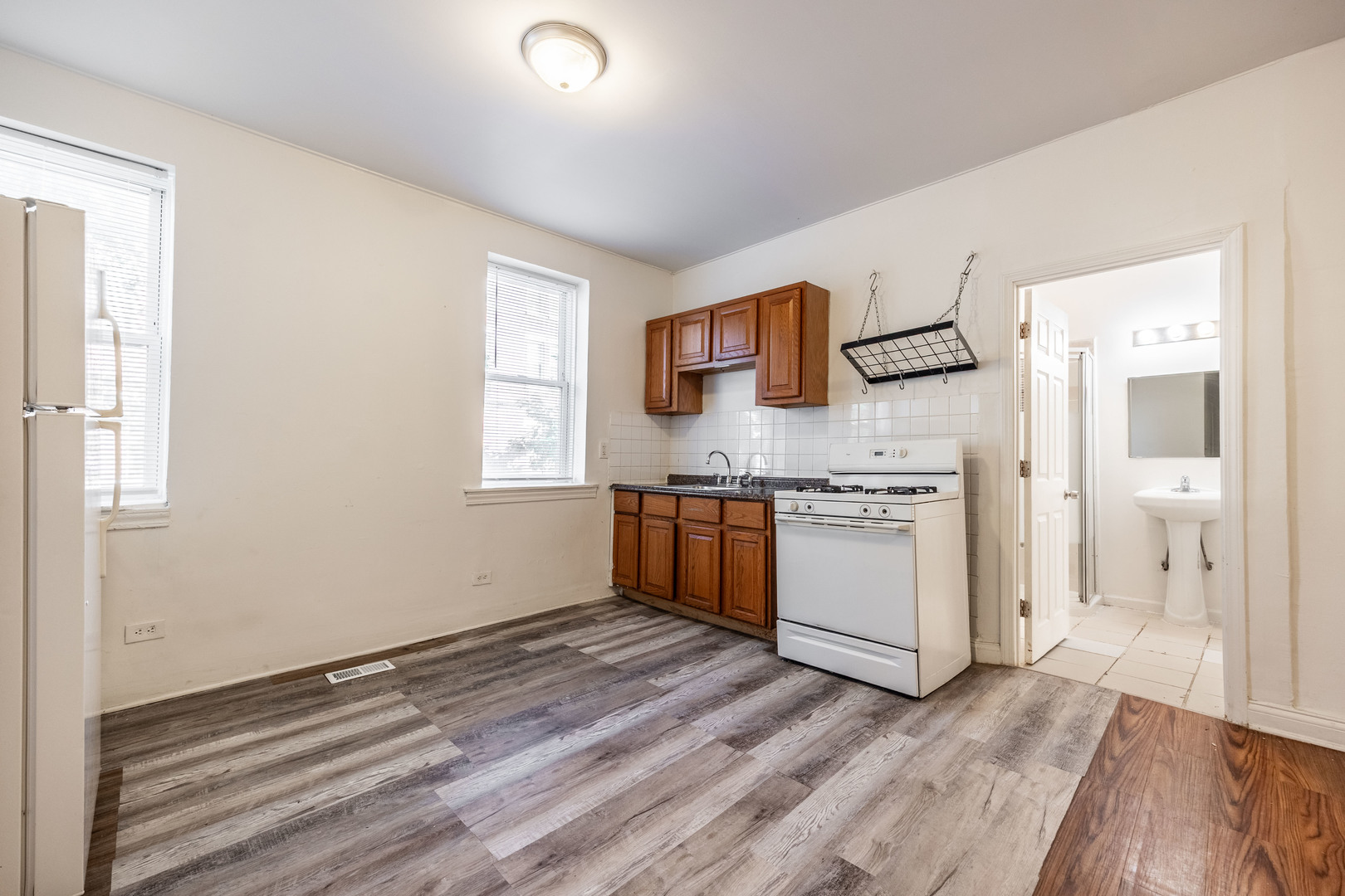 1900 South Throop Street, Unit 9 Chicago, IL 60608 - Photo 2 of 11 a kitchen with a stove and a refrigerator