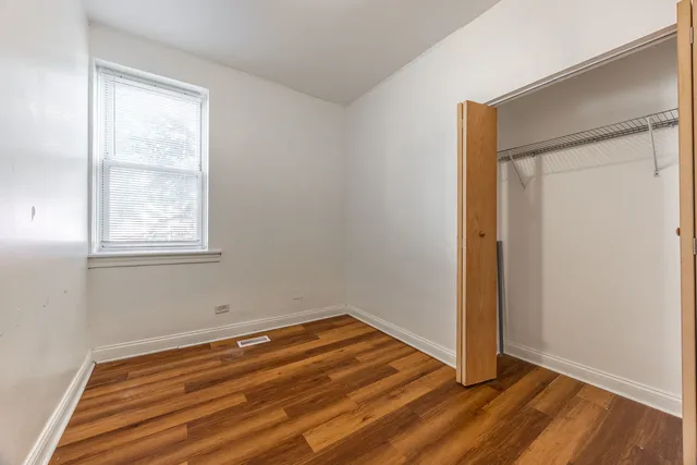 a view of room with window and hardwood floor