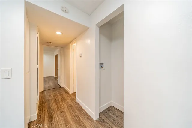 a view of hallway with wooden floor