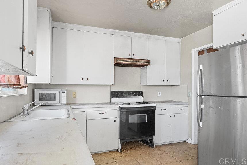 39635 Manzanita Dulce Road Boulevard, CA 91905 - Photo 7 of 33 a kitchen with stainless steel appliances a refrigerator sink and cabinets