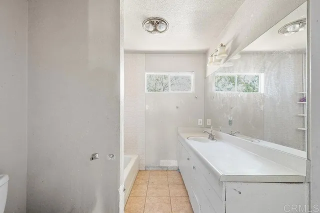 a view of a bathroom with sink and mirror