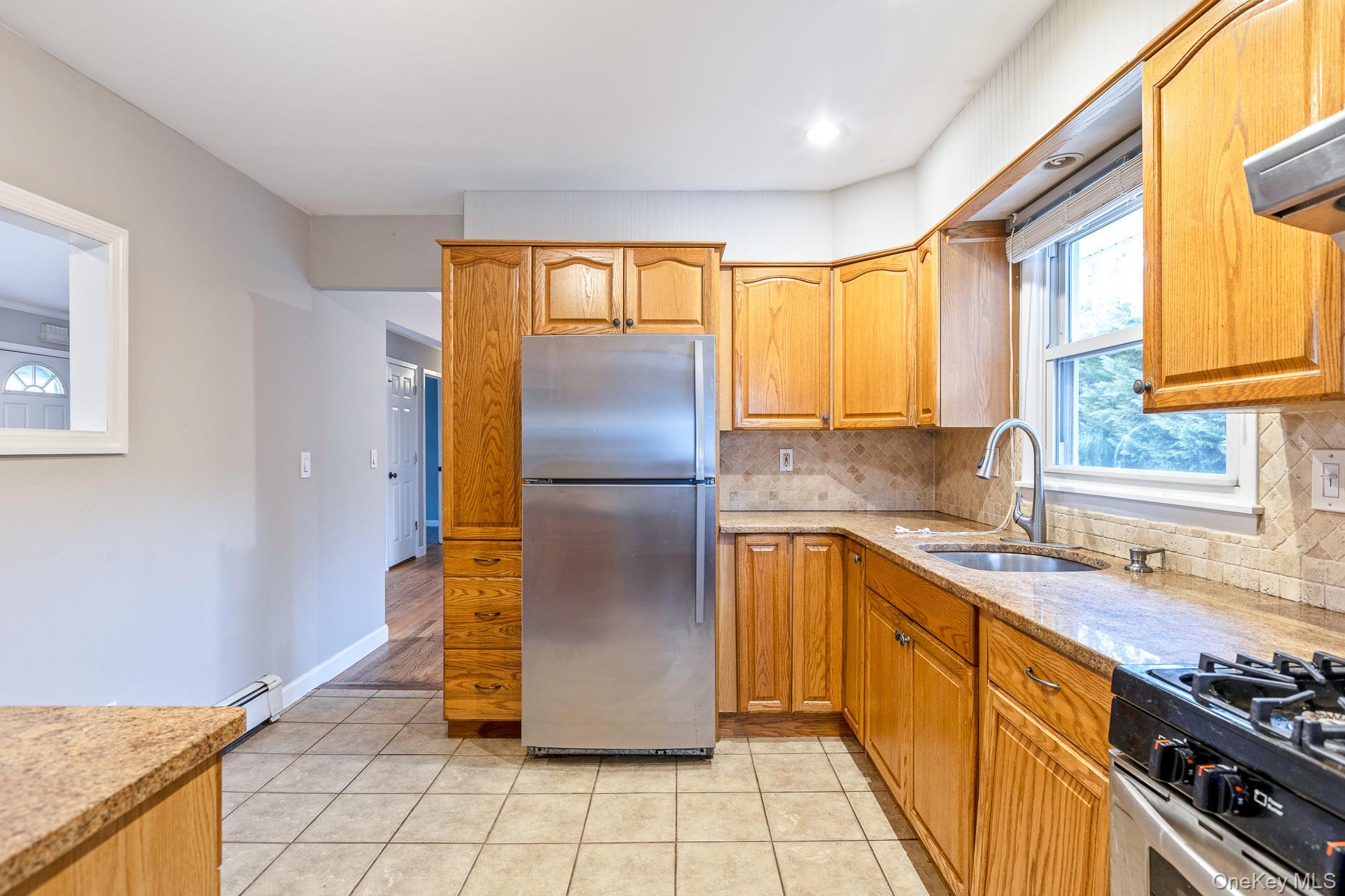 5 Richlee Street Blue Point, NY 11715 - Photo 11 of 27 a kitchen with stainless steel appliances granite countertop a refrigerator a sink and a stove