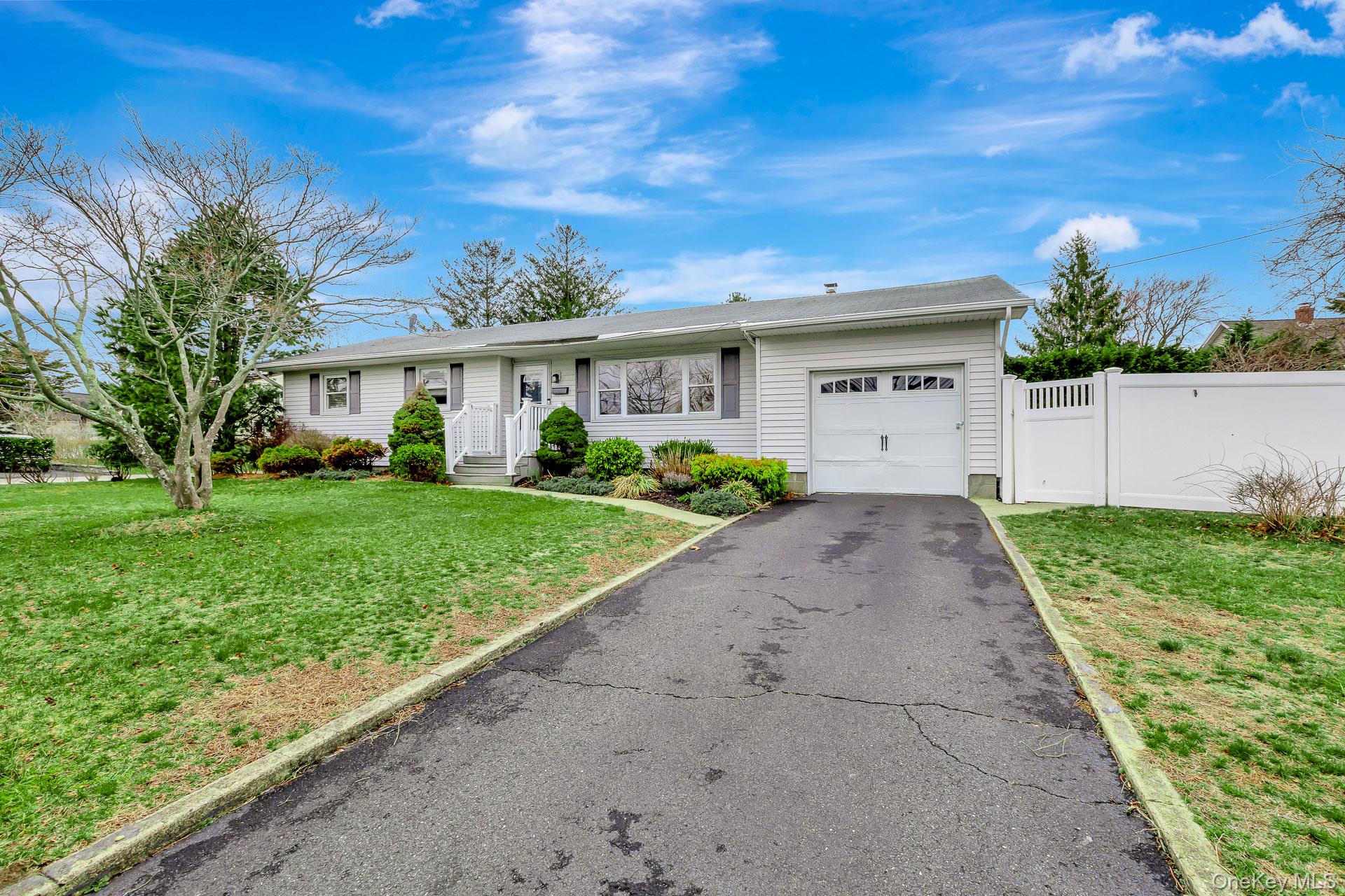 5 Richlee Street Blue Point, NY 11715 - Photo 2 of 27 a front view of house with yard and green space