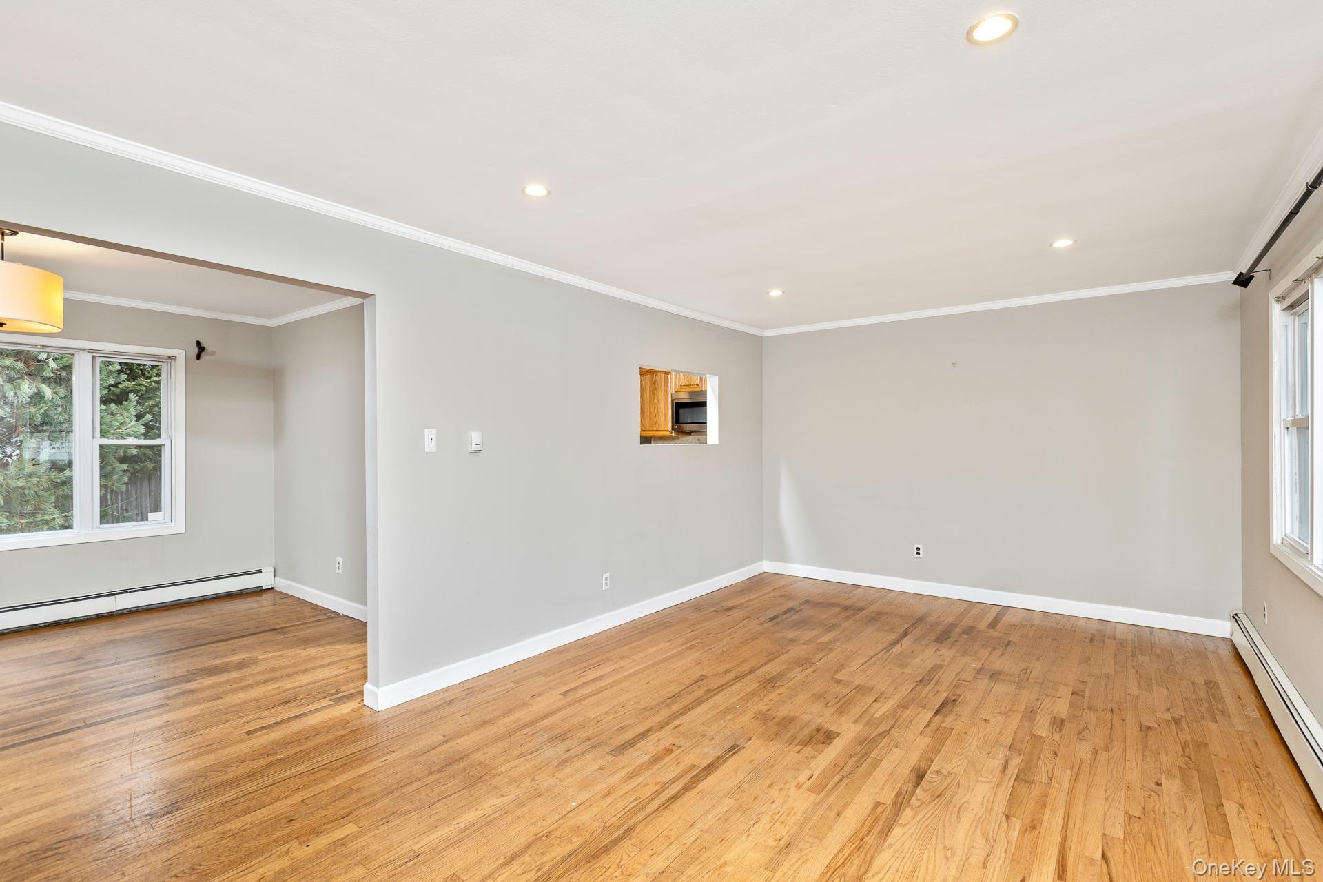 5 Richlee Street Blue Point, NY 11715 - Photo 4 of 27 a view of empty room with wooden floor and fan