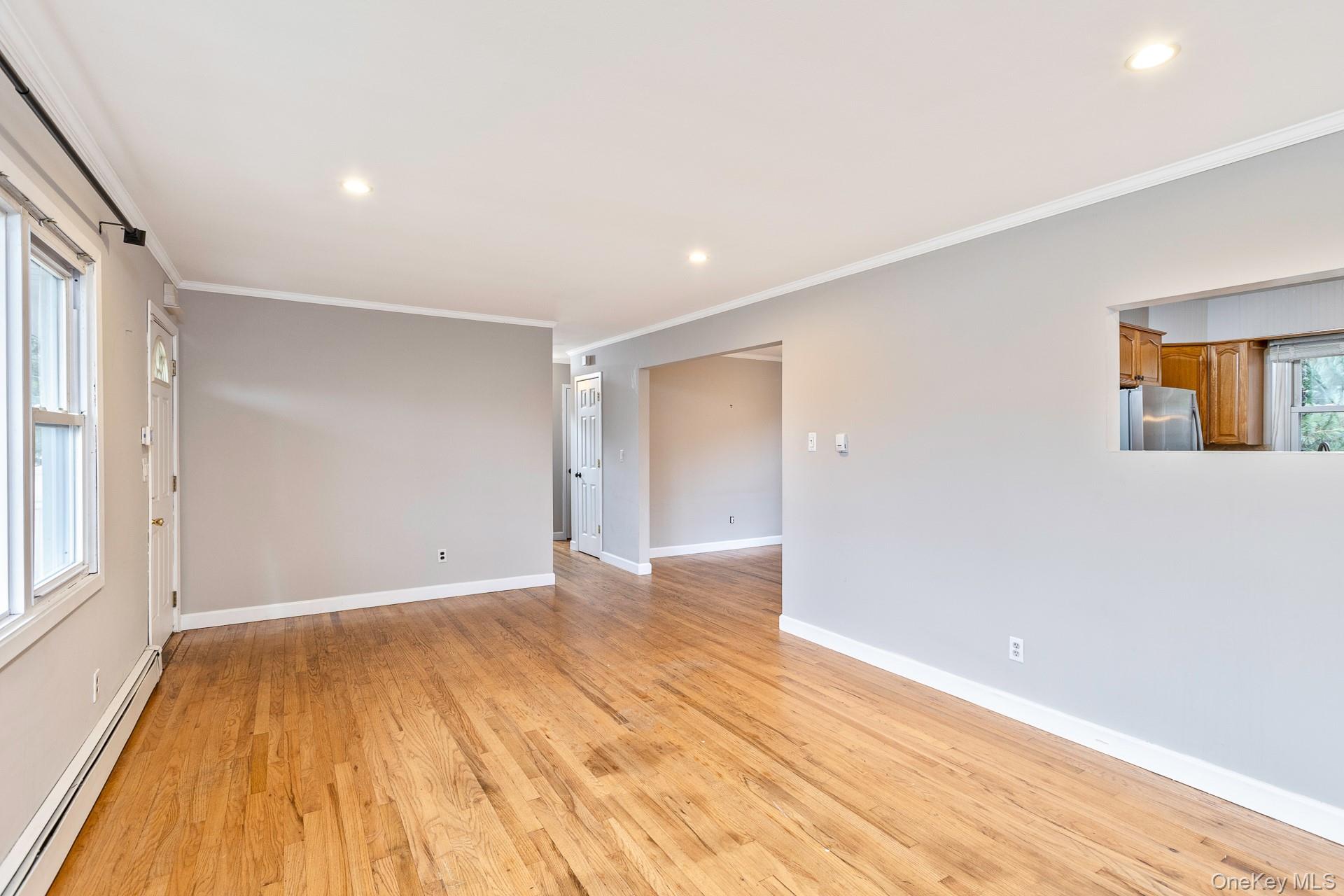 5 Richlee Street Blue Point, NY 11715 - Photo 6 of 27 a view of an empty room with wooden floor and a window