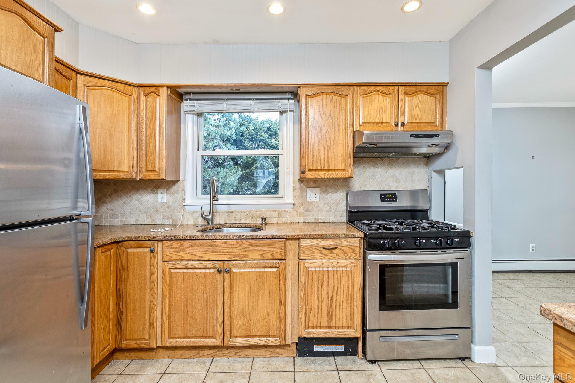 5 Richlee Street Blue Point, NY 11715 - Photo 10 of 27 a kitchen with granite countertop a stove and a sink