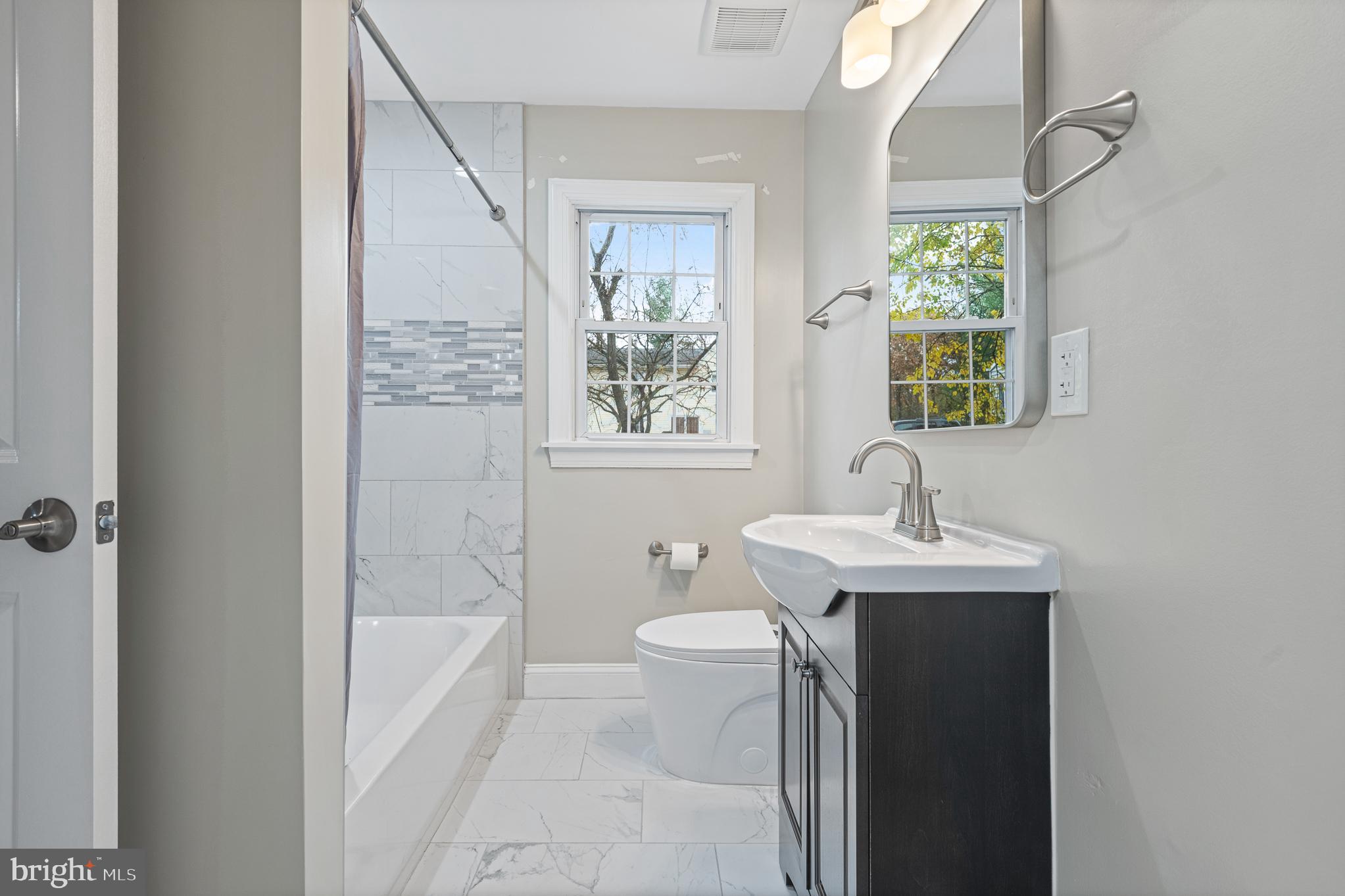 9217 Fowler Lane Lanham, MD 20706 - Photo 33 of 80 a bathroom with a sink toilet and shower
