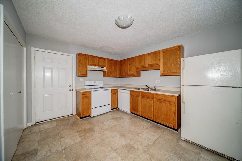 4355 East Paulding Drive, Unit A Dallas, GA 30157 - Photo 2 of 29 a kitchen with stainless steel appliances granite countertop a sink and a refrigerator