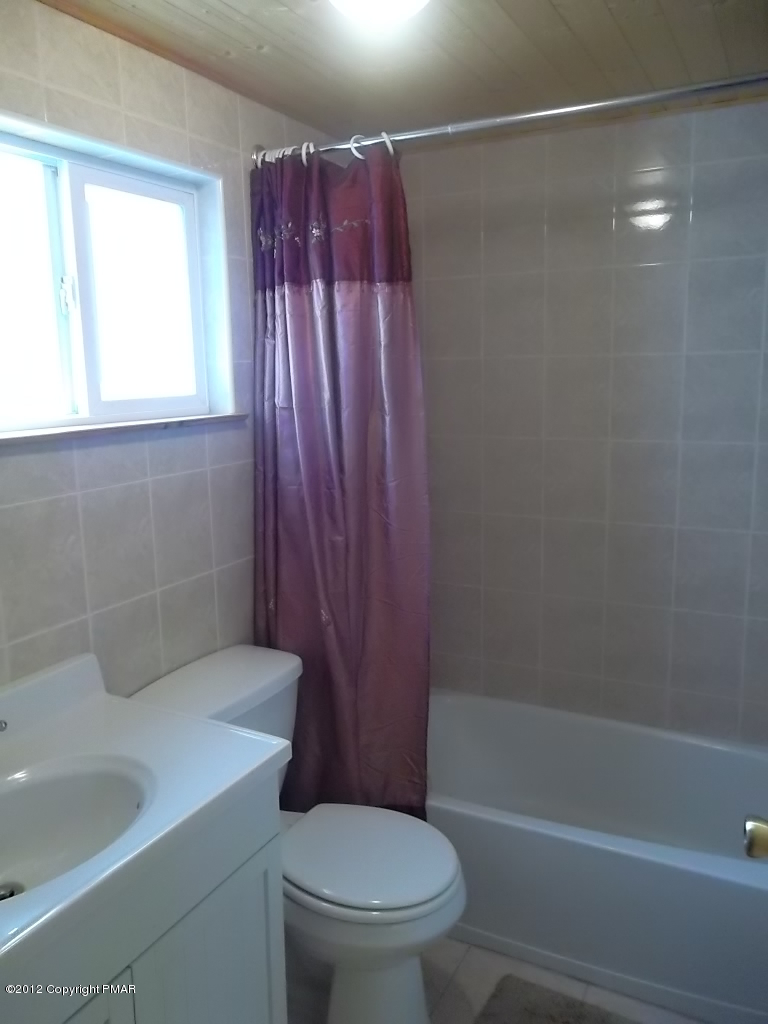 102 Rock Road Dingmans Ferry, PA 18328 - Photo 12 of 13 a bathroom with a shower a toilet and sink