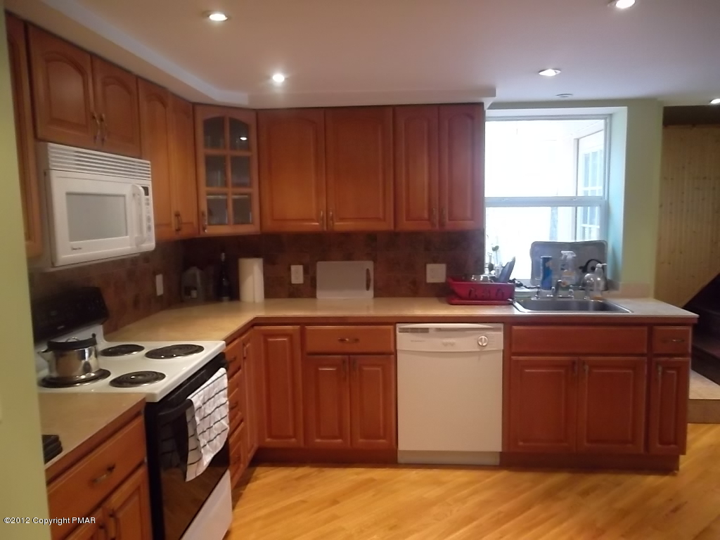 102 Rock Road Dingmans Ferry, PA 18328 - Photo 3 of 13 a kitchen with a stove a sink and a microwave
