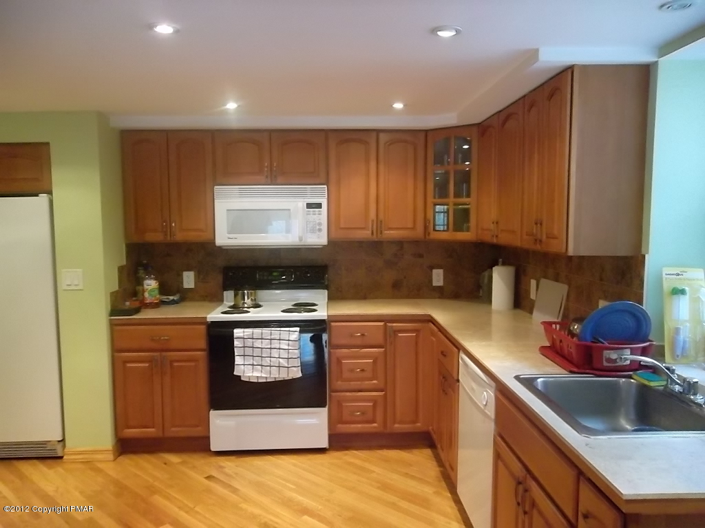 102 Rock Road Dingmans Ferry, PA 18328 - Photo 4 of 13 a kitchen with stainless steel appliances granite countertop a stove a sink and a microwave