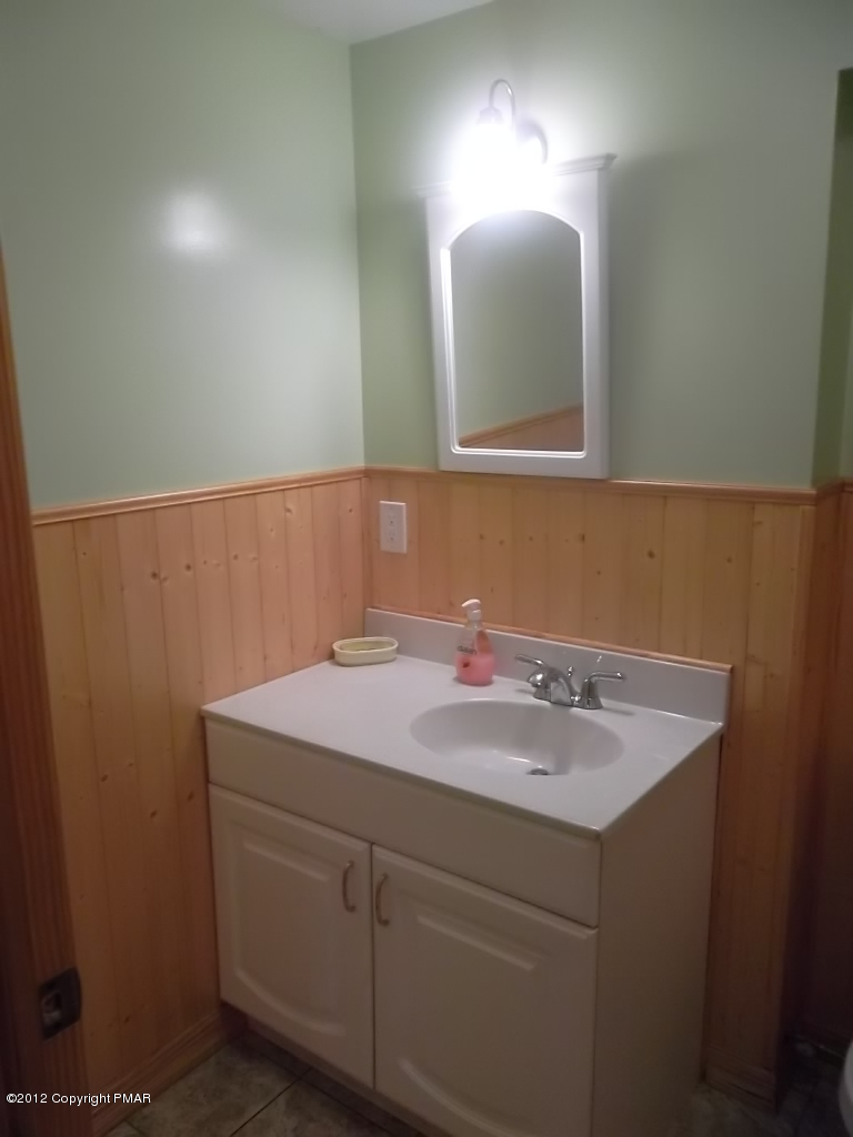 102 Rock Road Dingmans Ferry, PA 18328 - Photo 5 of 13 a bathroom with a sink and a mirror