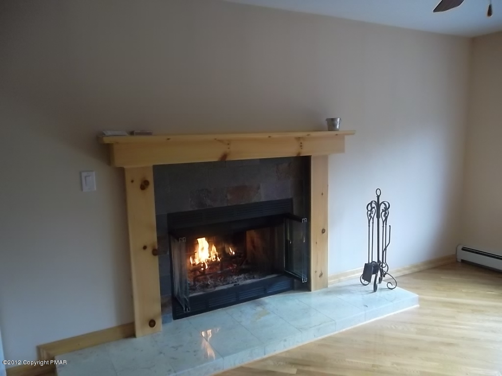 102 Rock Road Dingmans Ferry, PA 18328 - Photo 6 of 13 a living room with furniture and a fireplace