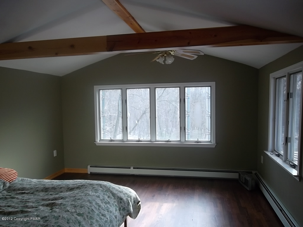 102 Rock Road Dingmans Ferry, PA 18328 - Photo 9 of 13 a bedroom with a bed and a window