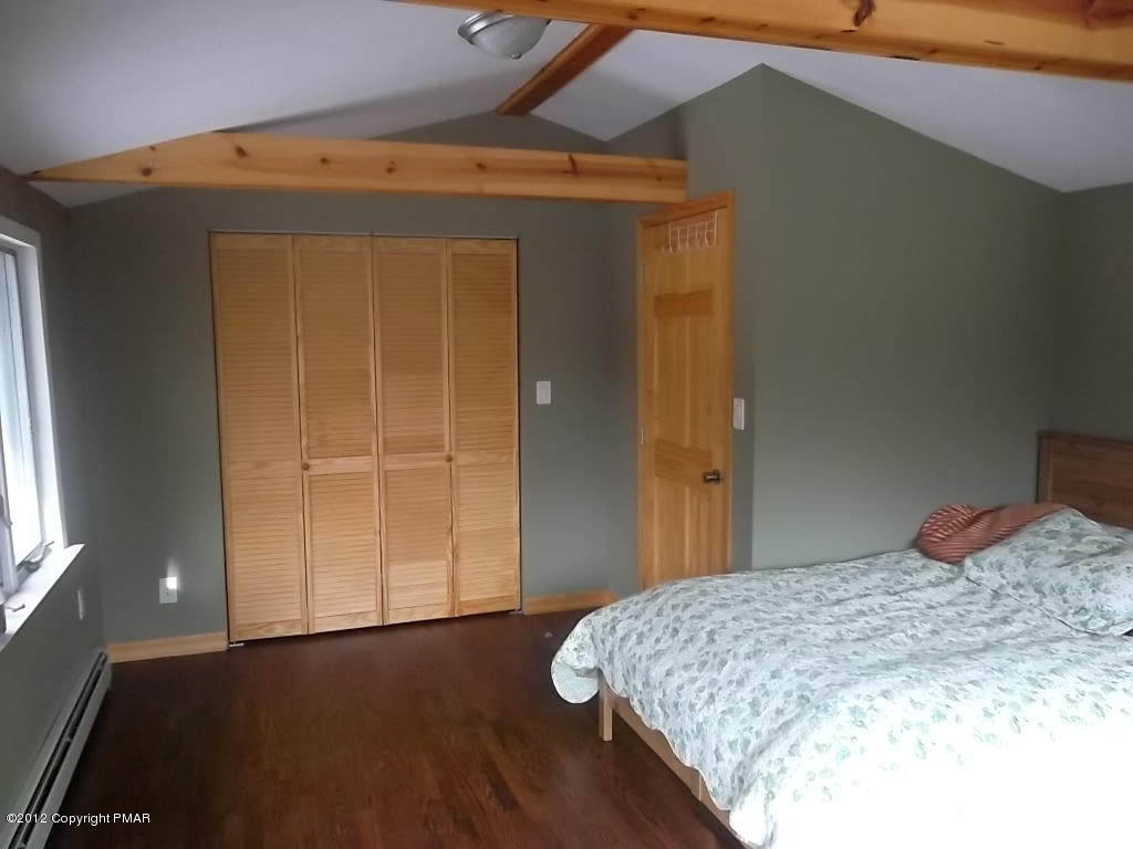102 Rock Road Dingmans Ferry, PA 18328 - Photo 10 of 13 a bedroom with a bed and wooden floor