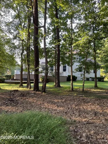 a view of a house with a backyard